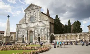 Piazza Santa Maria Novella, uno dei luoghi da vedere a Firenze, con la sua facciata rinascimentale e un prato fiorito.