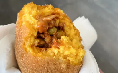 Arancino al ragù, un classico da provare se ti chiedi cosa mangiare a Catania. Croccante fuori, saporito dentro.