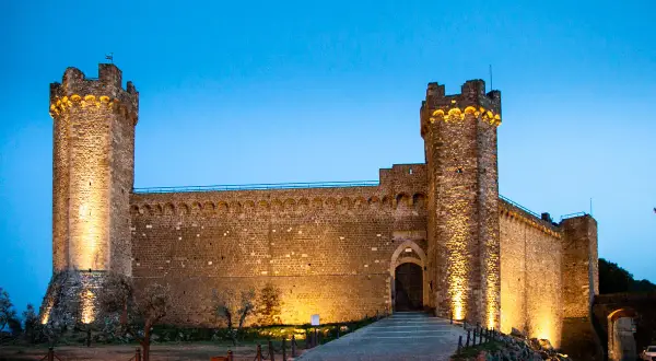 Fortezza di Montalcino illuminata di sera, un must per chi visita Montalcino cosa vedere in un giorno.