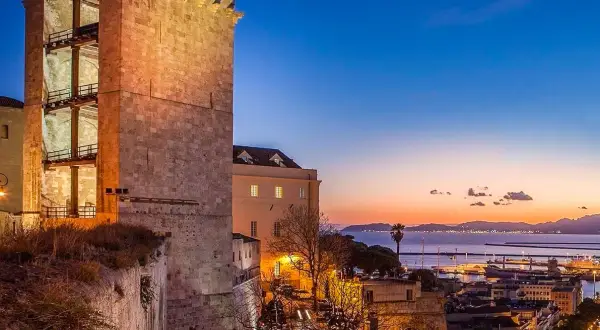 Torre medievale illuminata al tramonto, con vista sul porto e sul mare. Perfetto per scoprire cosa vedere a Cagliari in 3 giorni.