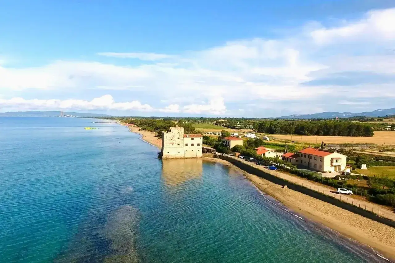 Spiaggia Torre Mozza, Follonica: mare cristallino, torre antica e case sul litorale. Come arrivare: strada panoramica lungo la costa.