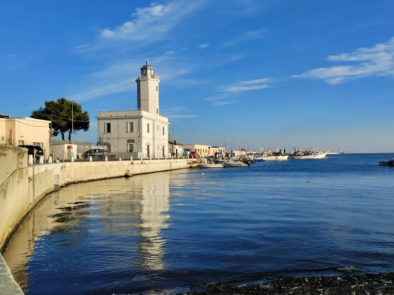 Il faro bianco e il porto con barche da pesca sono tra le cose da vedere a Manfredonia.