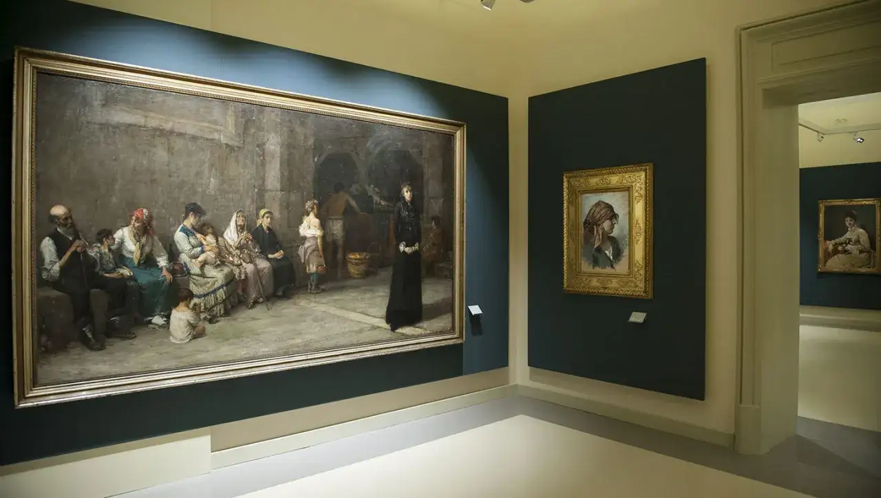 Interni della Villa Zito Palermo con opere d'arte. Un grande dipinto raffigura un gruppo di persone in attesa, mentre un ritratto più piccolo è appeso sulla parete adiacente.
