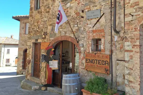 Un'enoteca in Chianti, cosa vedere: un gallo di legno accoglie i visitatori in questa bottega del vino con insegna "Chianti Classico".